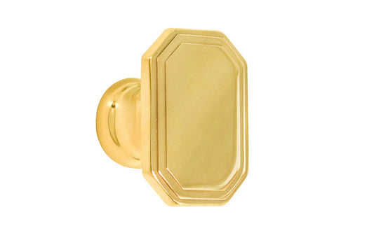 Classic "Art Deco" style cabinet knob with a retro 1930's look. It has an octagonal oblong shape with ring steps on the top. Made of high quality solid brass. Designed in the 1930's, Streamline Moderne, Art Deco style. 1-1/4" long x 7/8" wide. Unlacquered brass (will patina naturally over time). Non-lacquered brass. Un-lacquered brass.