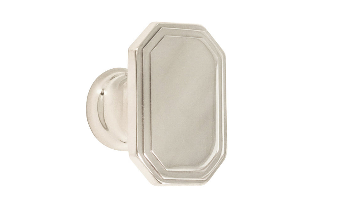 Classic "Art Deco" style cabinet knob with a retro 1930's look. It has an octagonal oblong shape with ring steps on the top. Made of high quality solid brass. Designed in the 1930's, Streamline Moderne, Art Deco style. 1-1/4" long x 7/8" wide. Polished Nickel Finish.