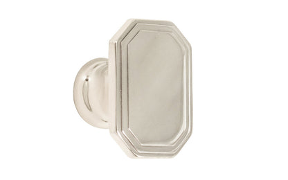 Classic "Art Deco" style cabinet knob with a retro 1930's look. It has an octagonal oblong shape with ring steps on the top. Made of high quality solid brass. Designed in the 1930's, Streamline Moderne, Art Deco style. 1-1/4" long x 7/8" wide. Polished Nickel Finish.