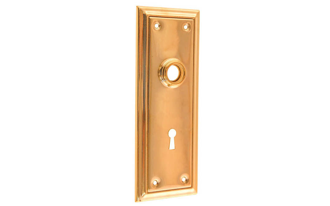 Brass Escutcheon Door Plate with Keyhole ~ Non-Lacquered Brass (will patina naturally over time) ~ Vintage-style Hardware · Classic & traditional design ~ Quality stamped brass material ~ 6-7/8" high x 2-1/2" wide ~ For solid or pre-bored (2-1/8") hole doors