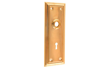 Brass Escutcheon Door Plate with Keyhole ~ Non-Lacquered Brass (will patina naturally over time) ~ Vintage-style Hardware · Classic & traditional design ~ Quality stamped brass material ~ 6-7/8" high x 2-1/2" wide ~ For solid or pre-bored (2-1/8") hole doors