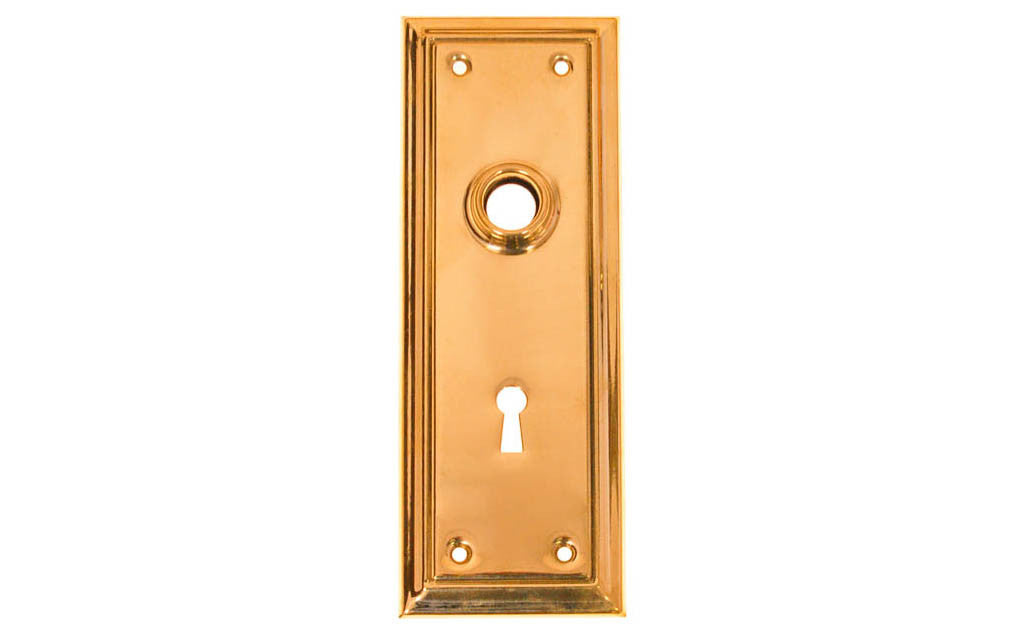 Brass Escutcheon Door Plate with Keyhole ~ Lacquered Brass Finish ~ Vintage-style Hardware · Classic & traditional design ~ Quality stamped brass material ~ 6-7/8" high x 2-1/2" wide ~ For solid or pre-bored (2-1/8") hole doors