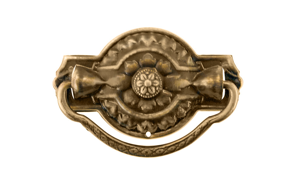 Vintage-style Traditional Hardware · Stamped brass drop pull in the Colonial Revival style. Made of stamped brass material with a nice detailed design of a "flower" at its center. Timeline: Early 20th Century, Colonial Revival, Depression Era, Waterfall style. Antique brass finish