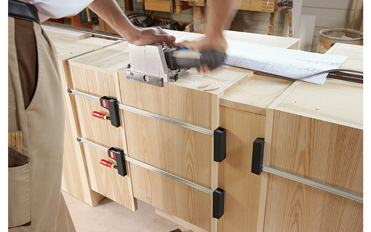 Bessey "UniKlamp" is a light duty universal clamp/spreader for bench top projects with a lighter frame & rail. Gentle touch jaws distribute the clamping pressure along the entire length of the rail & are ideal for sensitive work pieces & right angles. 24" max opening - 3-1/8" throat depth - Model UK3.024 - Wood handles - 091162006719