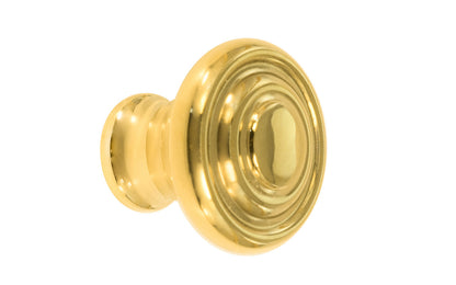 Classic "Art Deco" style cabinet round knob with a retro 1930's look. It has a round smooth shape with ring steps on the top. Made of high quality solid brass. Designed in the 1930's, Streamline Moderne, Art Deco style. 1-3/16" diameter. Unlacquered brass (will patina naturally over time). Non-lacquered brass. Un-lacquered brass.