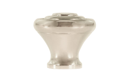 Classic "Art Deco" style cabinet round knob with a retro 1930's look. It has a round smooth shape with ring steps on the top. Made of high quality solid brass. Designed in the 1930's, Streamline Moderne, Art Deco style. 1-3/16" diameter. Polished Nickel finish.