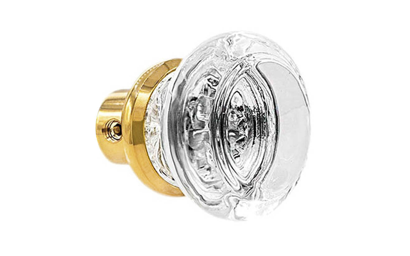 Single Classic Round Clear Glass Doorknob. A high quality & genuine glass doorknob with an attractive round design. The sparkling center point under glass amplifies reflected light to showcase beautiful facets. Solid brass base. Reproduction Glass Door Knobs. Traditional Round Glass Knobs. One knob. Lacquered Brass Finish.