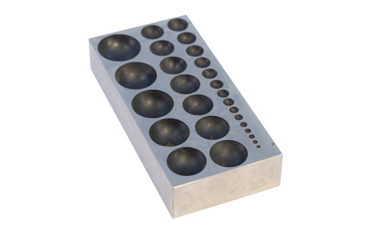 This steel dapping block with 27 round holes is ideal for use by hobbyists, jewelers, and craftsmen for shaping metals & other materials in jewelry making, metalworking, &  other applications. 2-1/2" x 5-1/8" x 1" block size.