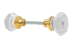 A high quality & genuine glass doorknob set with an attractive octagonal design. The sparkling center point under the glass amplifies reflected light to showcase beautiful facets. The rim of the brass base folds over the base of the glass knob for a secure grip. Lacquered Brass Finish