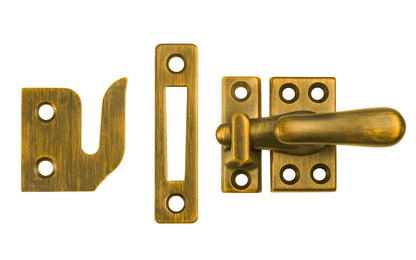 Classic & Traditional Solid Brass Casement Window Latch ~ Regular Size. 1-9/16" high x 7/8" wide latch turn base. Locks & tightens window frames or small doors. Reversible for right or left applications. Vintage-style casement window lock. Light Antique Brass Finish.