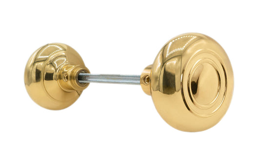 Pair of Traditional & Classic Brass Circle-Ring Design Doorknobs with spindle. Quality hollow core wrought brass doorknobs with an attractive circle-ring design. Reproduction Brass Door Knobs. Traditional Brass Knobs with Spindle. Set includes two knobs with spindle. Unlacquered Brass (will patina naturally over time). Non-Lacquered Brass