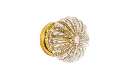 "Colonial Revival" Style Ribbed Glass Cabinet Knob with Unlacquered Brass Base. Made of genuine glass. The ribbed clear glass is carefully set into a handsome brass material base with a threaded shank. Non-lacquered brass (the un-lacquered brass will patina over time). Available in 1-3/16" diameter knob.