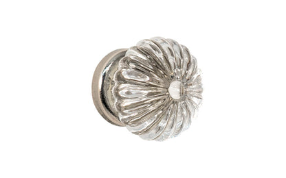 "Colonial Revival" Style Glass Cabinet Knob with Polished Nickel Base. Made of genuine glass. The ribbed glass is carefully set into a handsome brass material base with a threaded shank. Polished nickel finish on brass material base. Clear glass. Ribbed Glass Cabinet Knob. 1-3/16" Diameter Knob.