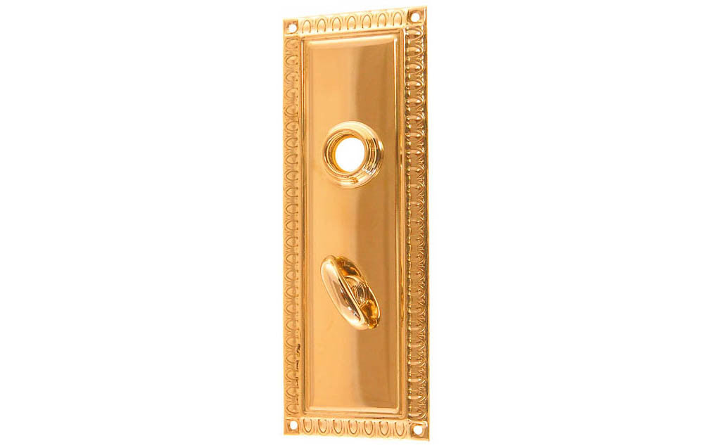 Brass Escutcheon Door Thumb Turn Plate ~ Lacquered Brass Finish ~ Vintage-style Hardware · Decorative beaded design ~ Quality stamped brass material ~ 7" high x 2-1/2" wide ~ For solid or pre-bored (2-1/8") hole doors