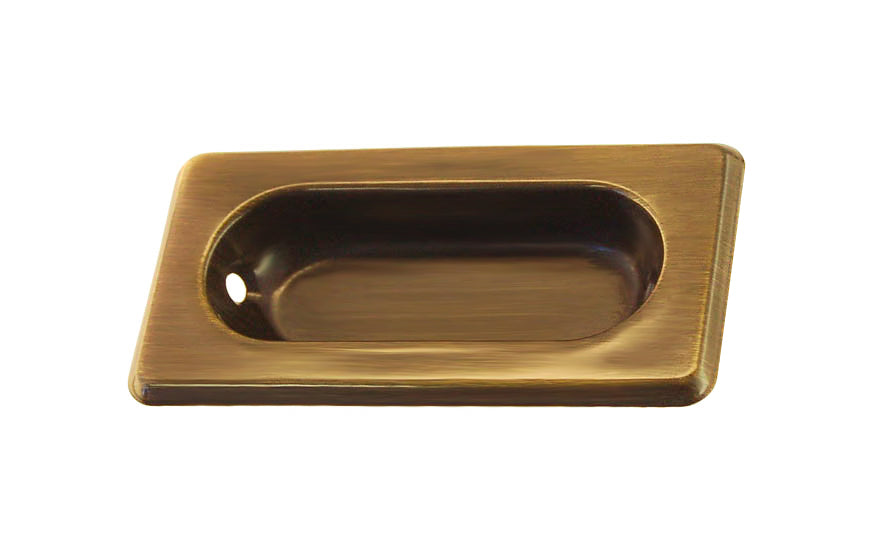 A classic & traditional recessed sash window lift made of quality stamped brass. For windows where a low profile is needed like inside shutters or windows with blinds. Low profile old-style sash lift with bevelled edges. Antique Brass Finish