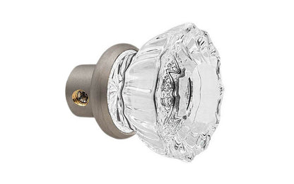 Single Classic Fluted Clear Glass Doorknob. A high quality & genuine glass doorknob with an attractive fluted design. The sparkling center point under glass amplifies reflected light to showcase beautiful facets. Solid brass base. Reproduction Glass Door Knobs. Traditional Fluted Glass Knobs. One knob. Brushed Nickel Finish.