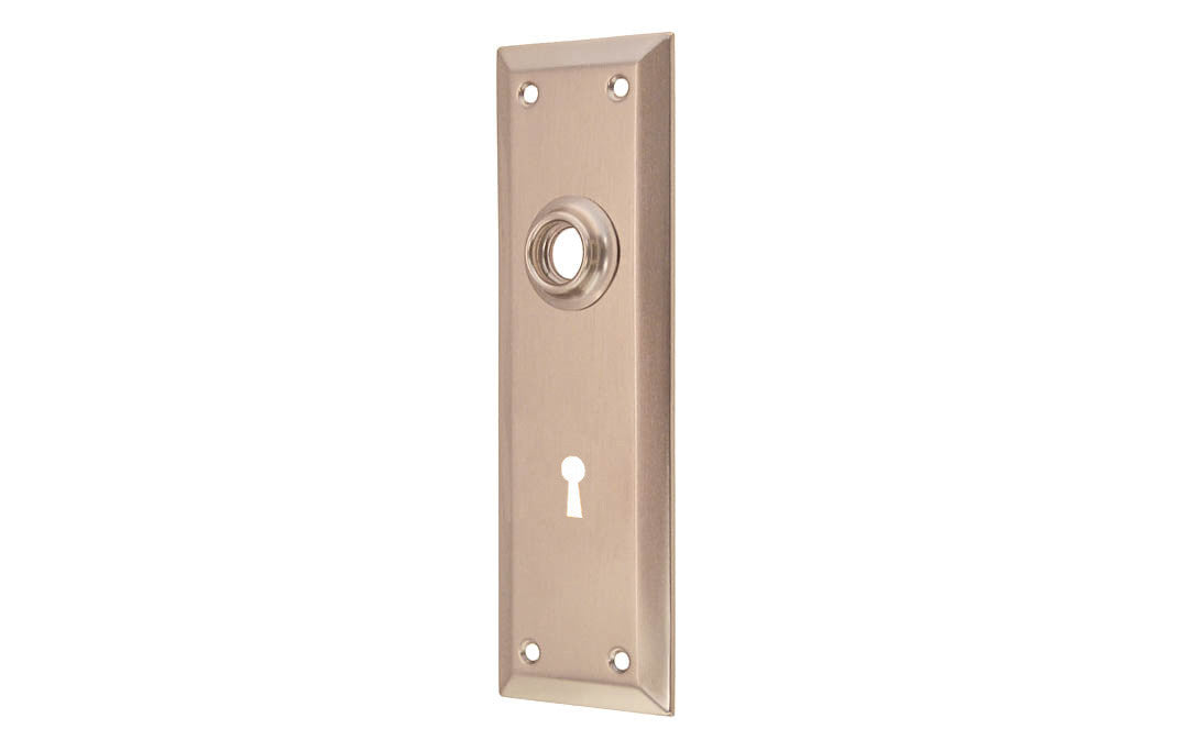 Brass Escutcheon Door Plate with Keyhole ~ Brushed Nickel Finish ~ A classic & handsome door escutcheon plate with a keyhole. Made of quality stamped brass material, this escutcheon plate is a well-made & durable piece of hardware. The plate may be used on modern doors with 2-1/8" pre-bored holes, or with the old-style mortise lock sets on traditional doors as well. 