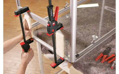 Bessey 24" DuoKlamp Clamp ~ DUO65-8 - One handed clamp & spreader. Clamp or spread with the turn of a button, no tools necessary. 24" max opening & 3-1/4" deep throat. Jaws resist flex & withstand up to 260 lb. of clamping force. Soft pressure caps prevent marring of wood by distributing pressure over a greater area.  