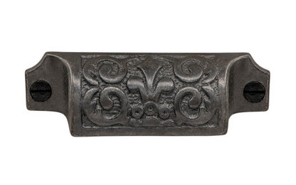 Rustic-looking & ornate cast iron bin pull with nice & charming "Fleur-de-Lis" detail. Made of cast iron material, this pull is thick with a good grip. This old-style bin pull is great for adding charm to your cabinets & drawers. Vintage-style finish with lacquer to resist rust. Victorian style pull. 3-1/4" on centers