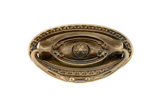 Vintage-style Traditional Hardware · Stamped brass drop pull in the Colonial Revival style. Made of stamped brass material with a nice detailed design of a "flower" at its center. Timeline: Early 20th Century, Colonial Revival, Depression Era, Waterfall style. Antique brass finish