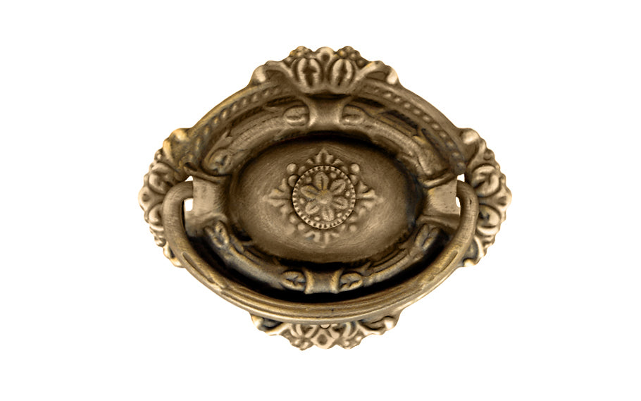 Vintage-style Traditional Hardware · Stamped brass drop pull in the Colonial Revival style. Made of stamped brass material with a nice detailed design of a "flower" at its center. Timeline: Early 20th Century, Colonial Revival, Depression Era, Waterfall style. Antique brass finish