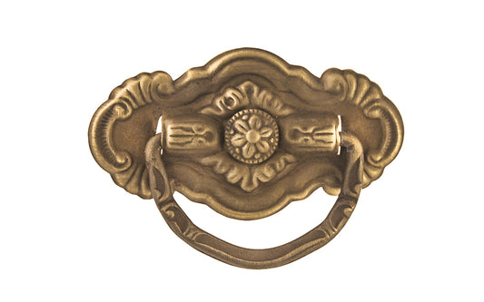 Vintage-style Traditional Hardware · Stamped brass drop pull in the Colonial Revival style. Made of stamped brass material with a nice detailed design of a "flower" at its center. Timeline: Early 20th Century, Colonial Revival, Depression Era, Waterfall style. Antique brass finish