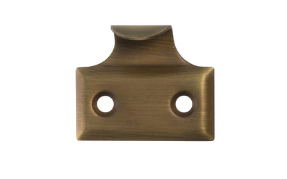 A classic & durable hook sash lift made of stamped brass with beveled edges. This traditional piece of hardware is used for sashes, windows, tambour drops. Hook-style sash lift. Antique Brass Finish.