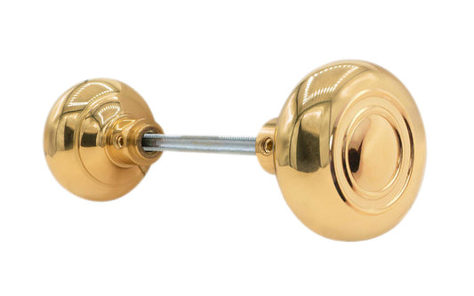 Pair of Traditional & Classic Brass Circle-Ring Design Doorknobs with spindle. Quality hollow core wrought brass doorknobs with an attractive circle-ring design. Reproduction Brass Door Knobs. Traditional Brass Knobs with Spindle. Set includes two knobs with spindle. Unlacquered Brass (will patina naturally over time). Non-Lacquered Brass