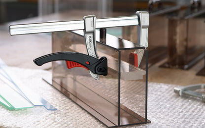 Bessey 12" KliKlamp Light Duty Lever Clamp KLI3.012 creates up to 260 lbs. of clamping force. Positive locking ratchet action. Made of sturdy magnesium which makes it lightweight & strong. Fixed arm with v-grooves holds round & angular components firmly in place. 12" clamping capacity - 3" throat depth. Made in Germany