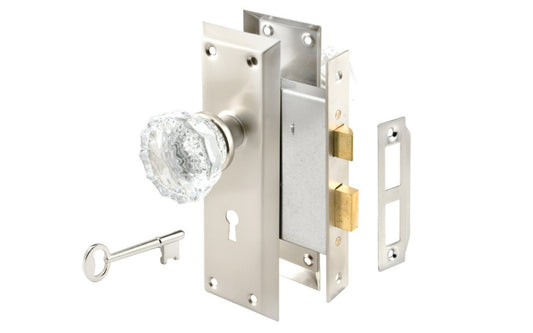 A basic privacy mortise lockset & skeleton keys with a satin nickel finish on steel material & glass knobs. Includes lock body, two knobs, threaded spindle, two escutcheon trim plates, strike, screws, & two skeleton keys. Lockset may be used for right or left installations. Not designed for exterior use. Model E 2496.