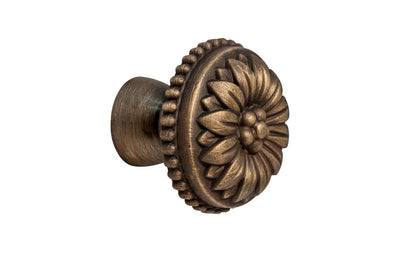 Traditional & classic "French Style" cabinet knob with an elegant flower design & beaded trim. Made of high quality solid brass, his knob has a weighty & durable feel. Great for cabinets, furniture & drawers. The knob is designed in the Late 19th Century style of hardware. Antique brass finish on solid brass material. Available in 1-1/8" diameter & 1-1/2" diameter 