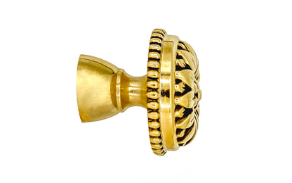 Traditional & classic "French Style" cabinet knob with an elegant flower design & beaded trim. Made of high quality solid brass, his knob has a weighty & durable feel. Great for cabinets, furniture & drawers. The knob is designed in the Late 19th Century style of hardware. Unlacquered brass (will patina over time). Available in 1-1/8" diameter knob & 1-1/2 diameter knob.