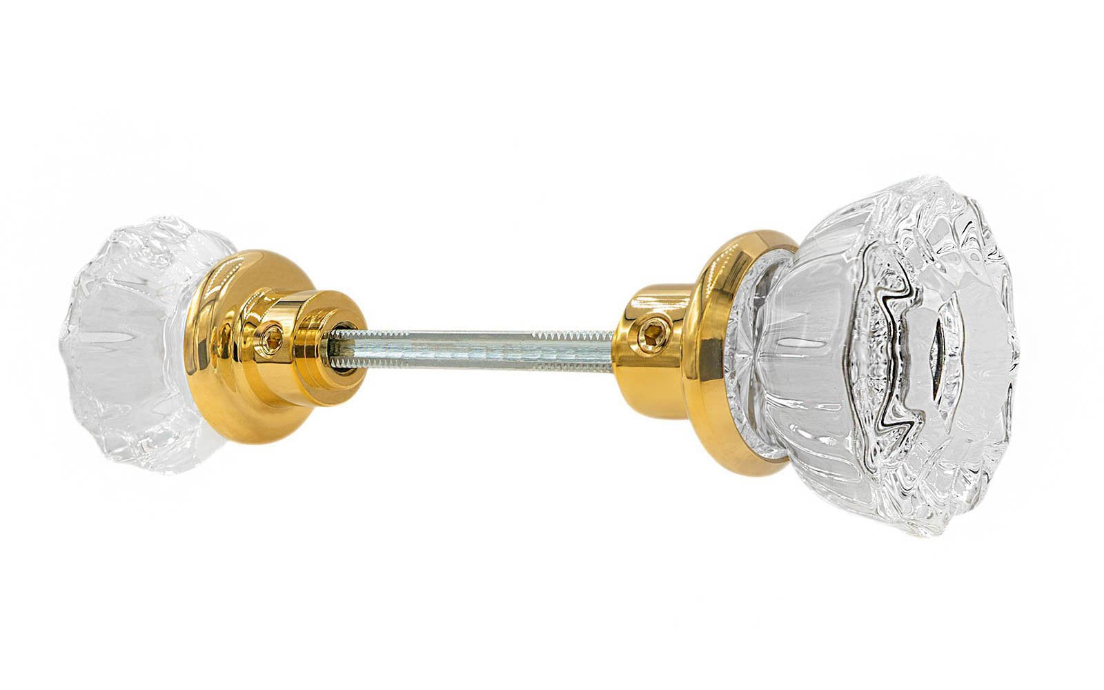 Pair of Classic Fluted Clear Glass Doorknobs with spindle. A high quality & genuine glass doorknob set with an attractive fluted design. The sparkling center point under glass amplifies reflected light to showcase beautiful facets. Solid brass base. Reproduction Glass Door Knobs. Traditional Fluted Glass Knobs. Unlacquered brass (will patina naturally), Non-Lacquered Brass.