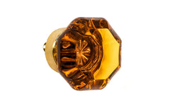 Elegant & classic octagonal cabinet glass knob with an attractive "Amber" color. The glass is carefully set into a handsome solid brass base with a threaded shank in the back. Unlacquered solid brass base (will patina over time). Un-lacquered Brass. Octagon shape knob. 1-1/4" Diameter Knob