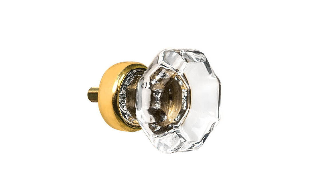 Elegant & classic octagonal cabinet glass knob with attractive genuine clear glass. The glass is carefully set into a handsome solid brass base with a threaded shank in the back. Unlacquered brass base - Will patina naturally over time. Octagon shape knob. 1