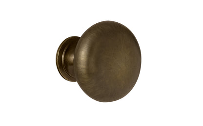 Vintage-style Hardware · Traditional & Classic 1-1/4" Diameter Brass Knob with an Antique Brass Finish. Made of high quality brass, this stylish round cabinet knob has a smooth look & feel on a pedestal shaped base. Works great in kitchens, bathrooms, on furniture, cabinets, drawers. Authentic reproduction hardware.