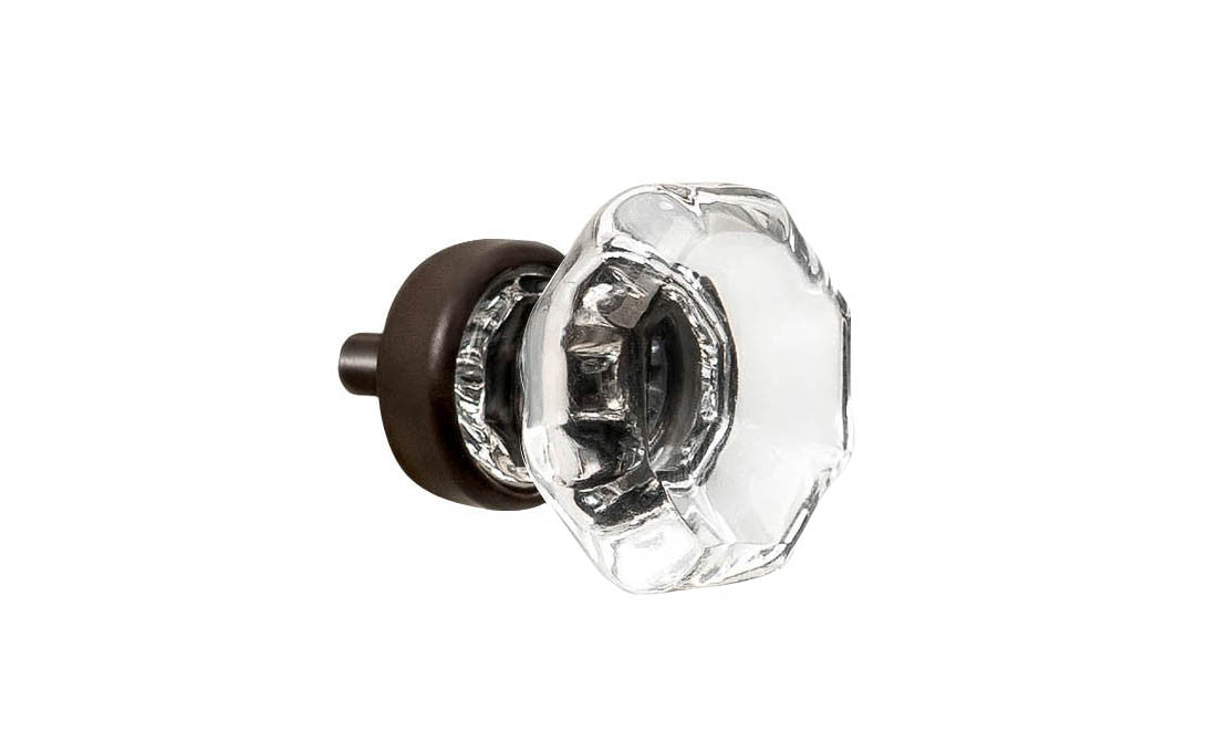 Elegant & classic octagonal cabinet glass knob with attractive genuine clear glass. The glass is carefully set into a handsome solid brass base with a threaded shank in the back. Oil Rubbed Bronze Finish on solid brass base. Octagon shape knob. 1" Diameter Knob 