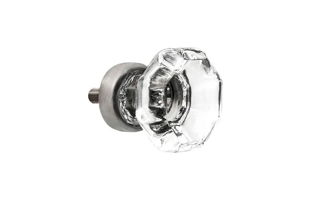 Elegant & classic octagonal cabinet glass knob with attractive genuine clear glass. The glass is carefully set into a handsome solid brass base with a threaded shank in the back. Brushed nickel finish on solid brass base. Octagon shape knob. 1" Diameter Knob 