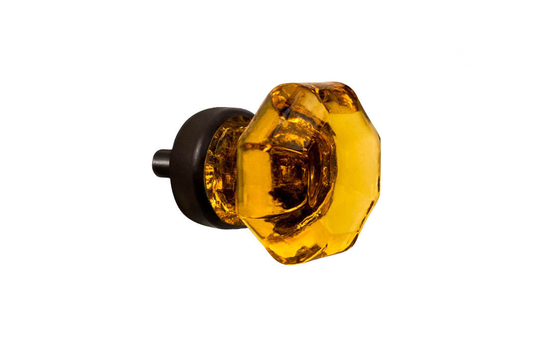 Elegant & classic octagonal cabinet glass knob with an attractive "Amber" color. The glass is carefully set into a handsome solid brass base with a threaded shank in the back. Oil rubbed bronze finish on solid brass base. Octagon shape knob. 1" Diameter Knob