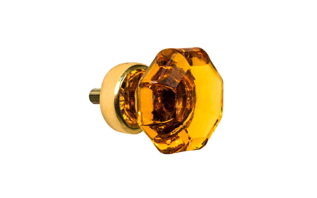 Elegant & classic octagonal cabinet glass knob with an attractive "Amber" color. The glass is carefully set into a handsome solid brass base with a threaded shank in the back. Unlacquered solid brass base (will patina over time). Un-lacquered Brass. Octagon shape knob. 1" Diameter Knob
